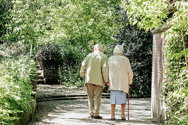 Two older adults sharing a walk
