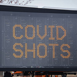 A digital sign reads 'COVID Shots'