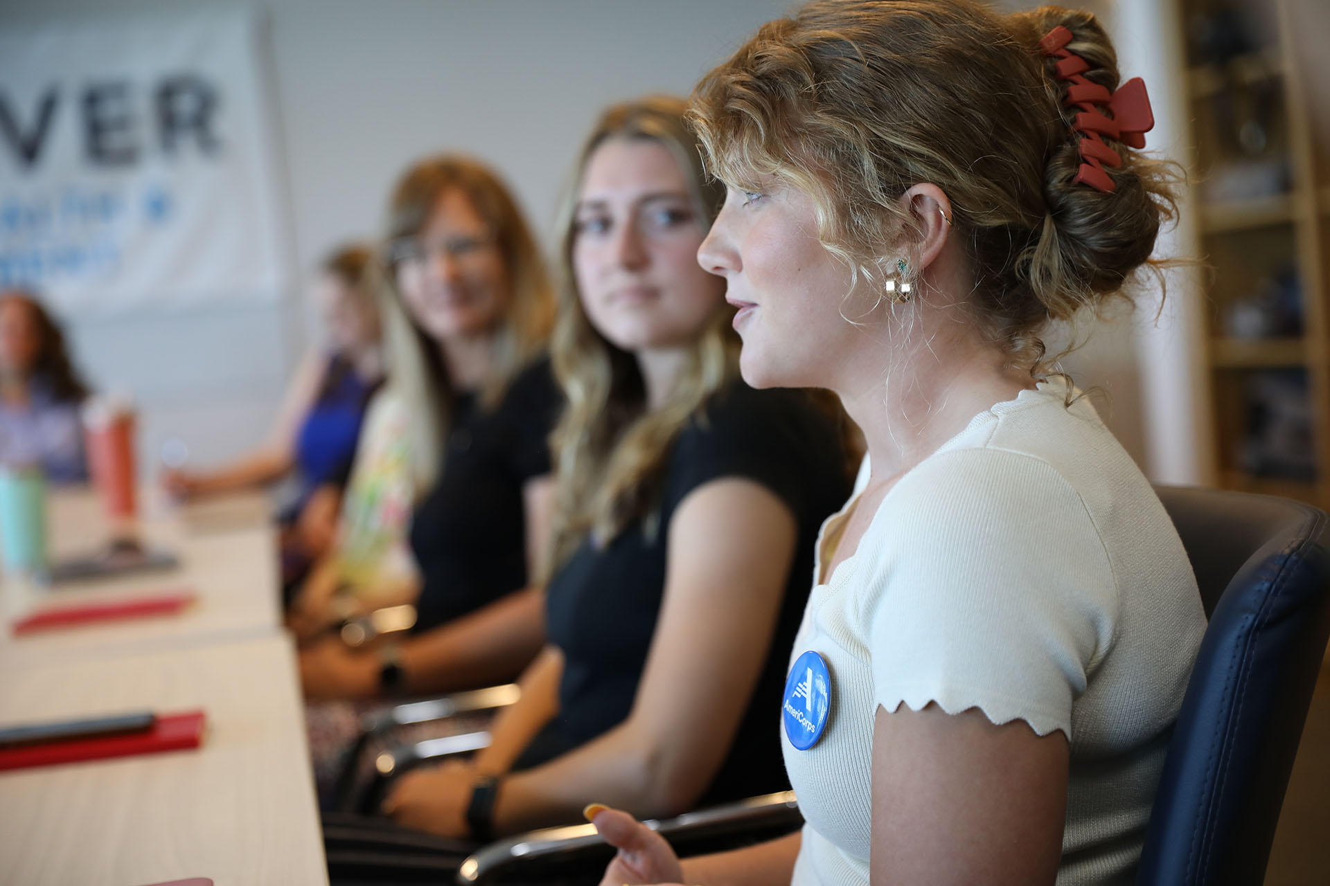Public Health AmeriCorps member Emily Evans sits with fellow program members at a meeting at the Denver Department of Public Health and Environment