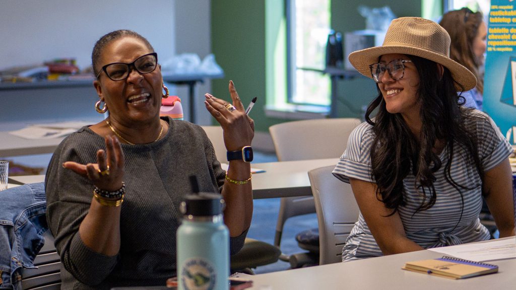 Wanda Eiland and Okany Rivas share a laugh and connection at Colorado's Regional Health Connectors Program Retreat