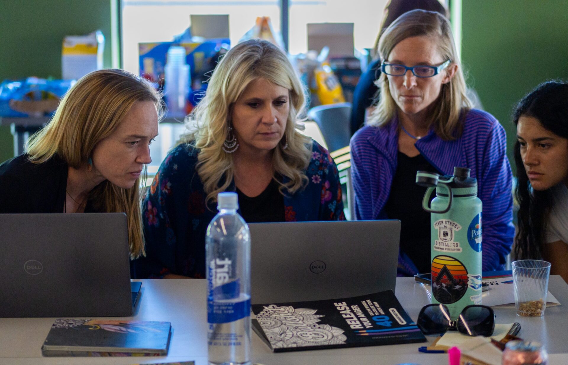 (L-R) RHCs Megan Wise, Angela Rodriguez, Jamie Fanselow, and Kayana Casias look at computer