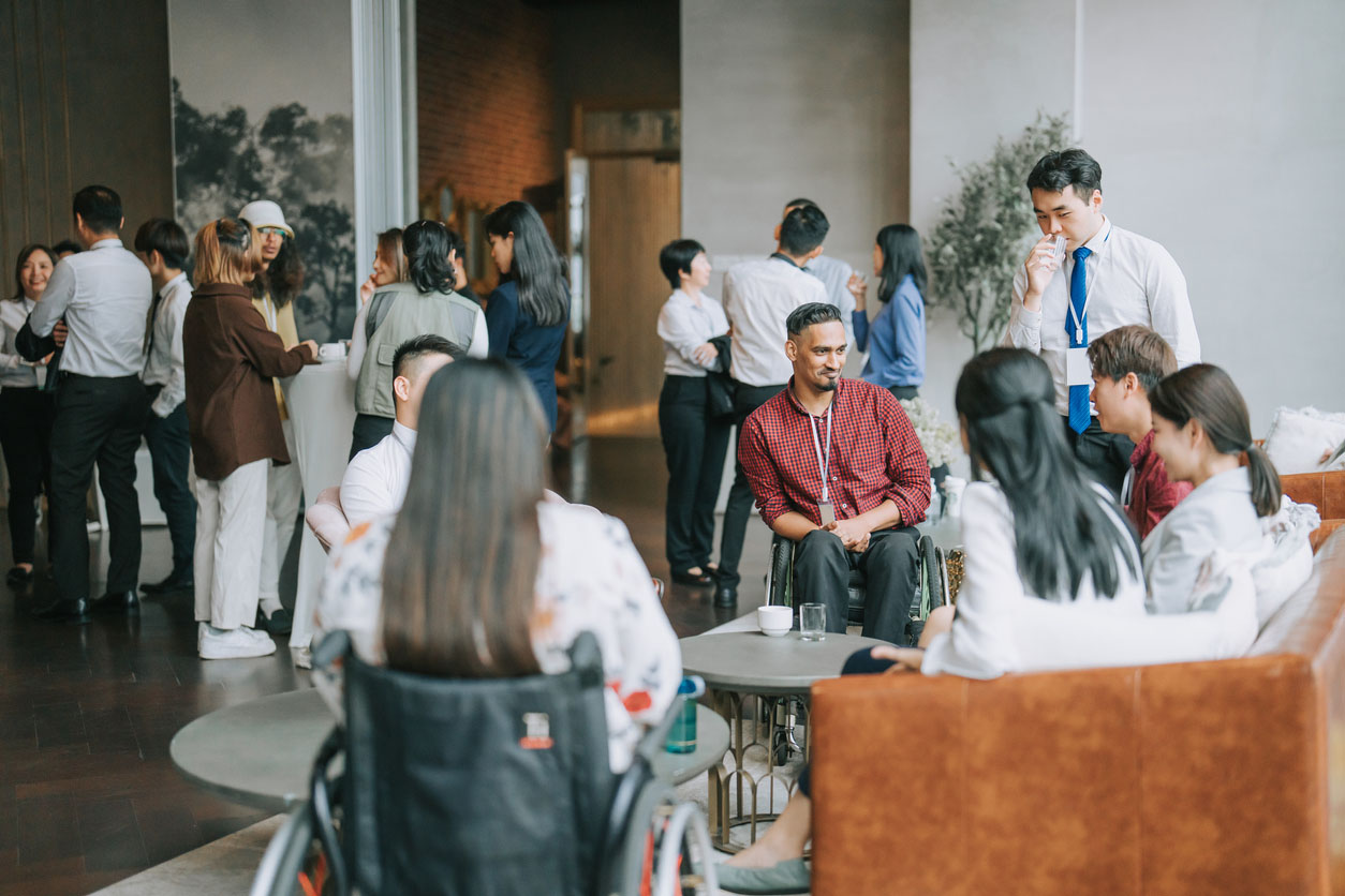 A diverse group of health care professionals gather in a clinical setting